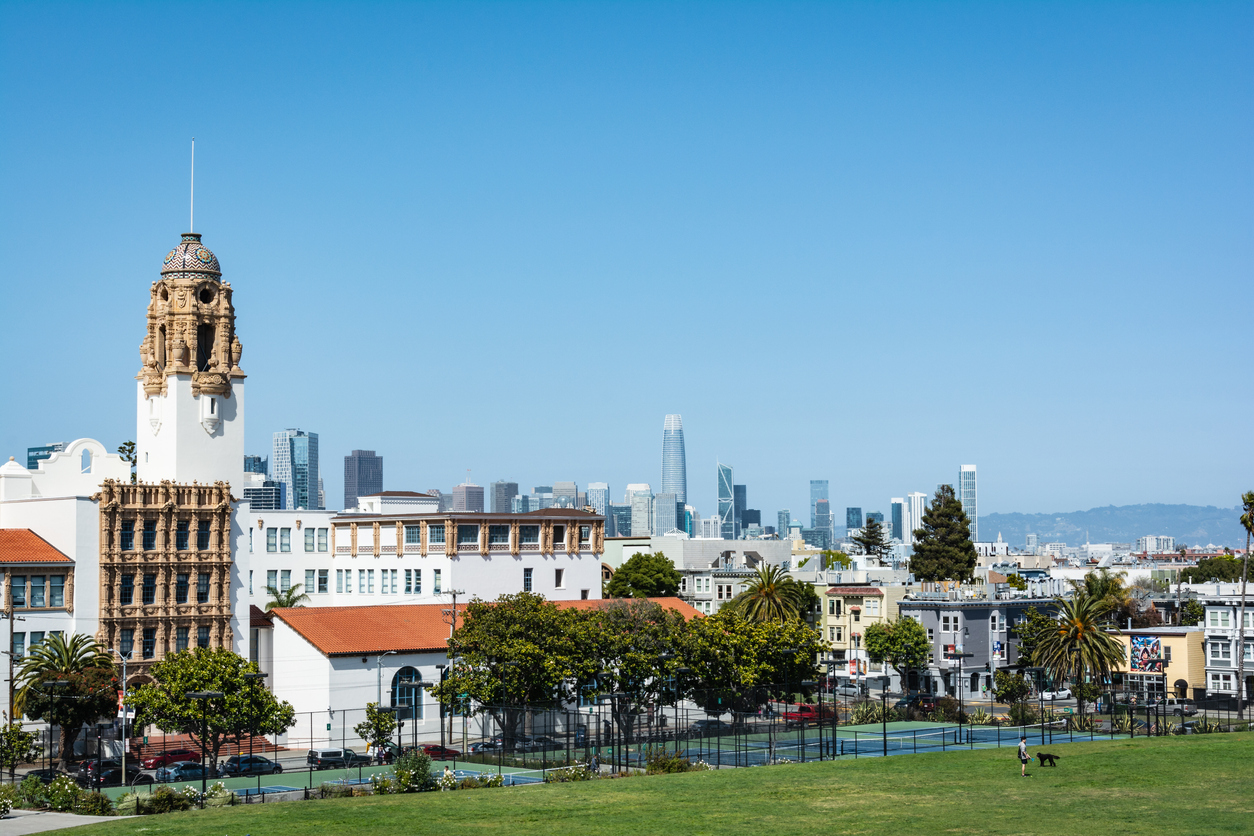 Mission Dolores Basilica and San Francisco skyline view from Dolores Park, California
