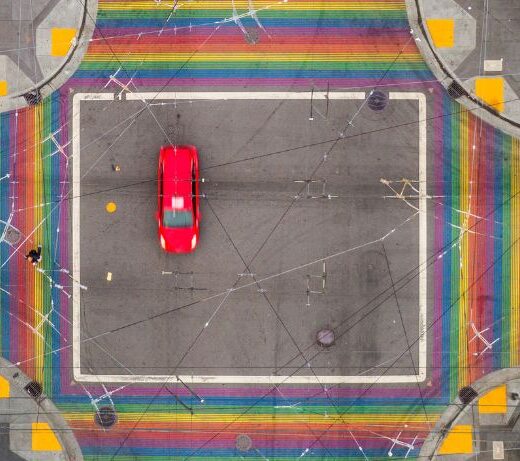 overhead shot of care with rainbow crosswalks