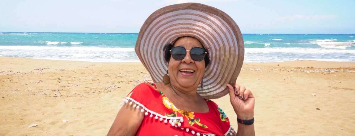 older woman in sunhat at beach